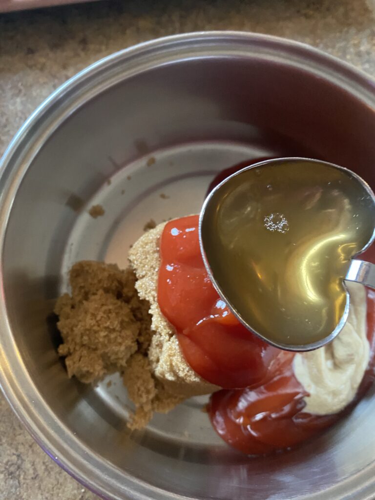 The ingredients for BBQ sauce in a metal bowl