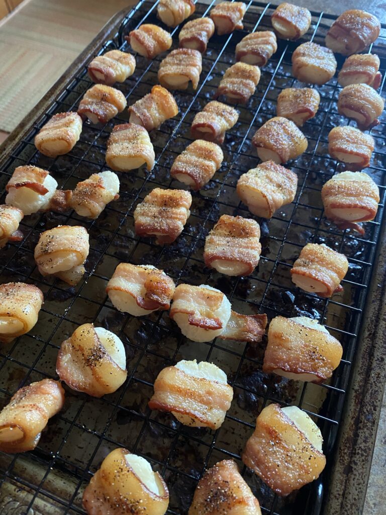 The cooked bacon wrapped chestnuts on a baking grate
