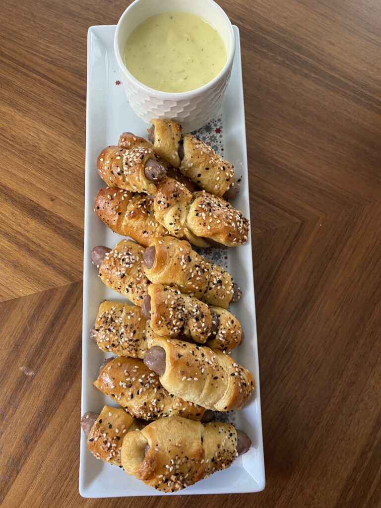 Breakfast sausage dippers with Hollandaise sauce seen from above