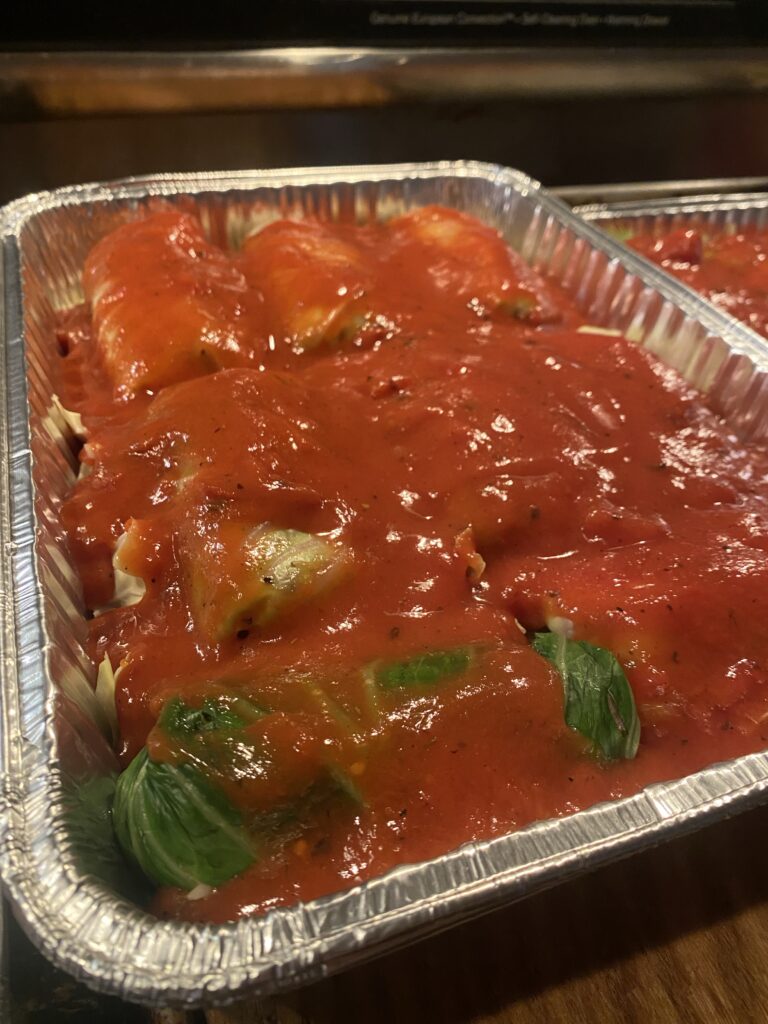 Stuffed cabbages topped with tomato sauce