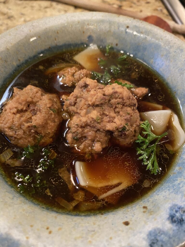 A bowl of liver dumpling soup