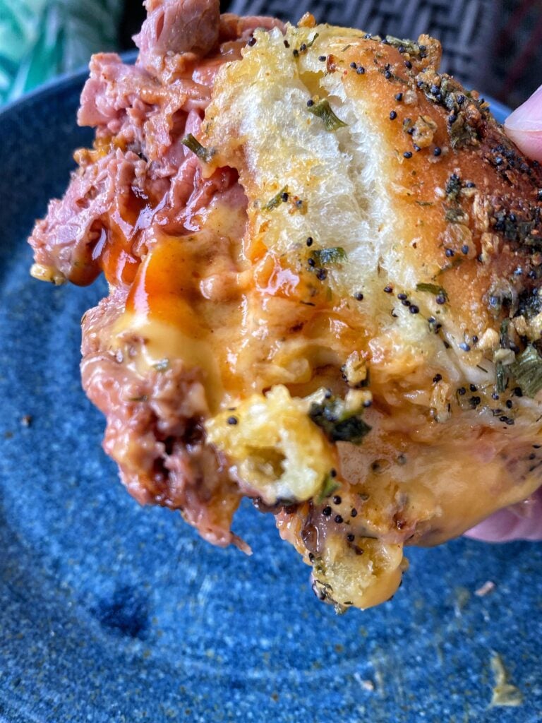 A close up of a beef and cheddar slider