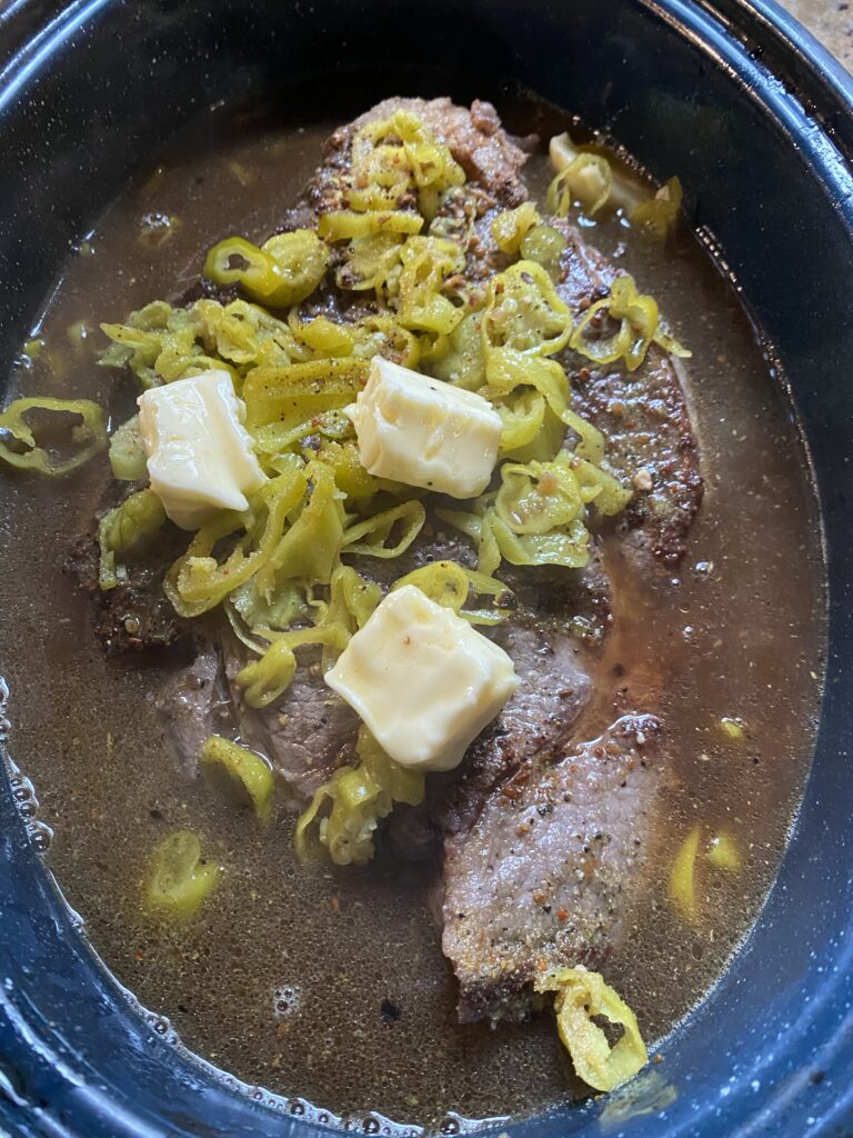 Beef in the slow cooker with spicy peppers and butter