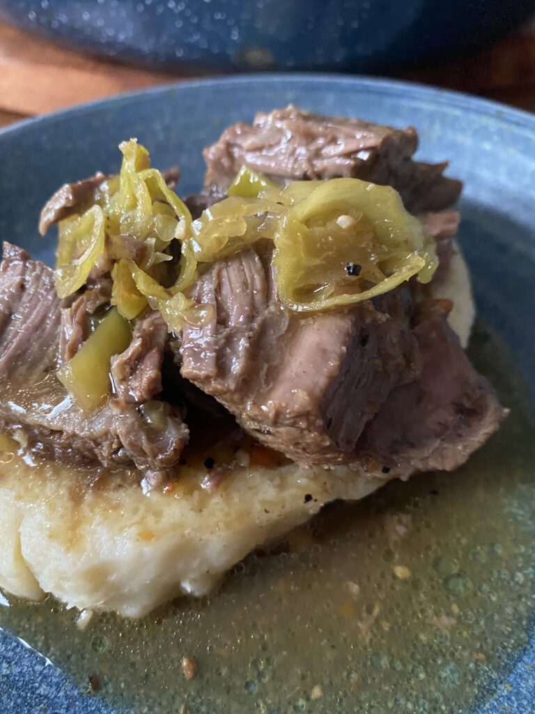 A close up of Italian beef on a bread dumpling