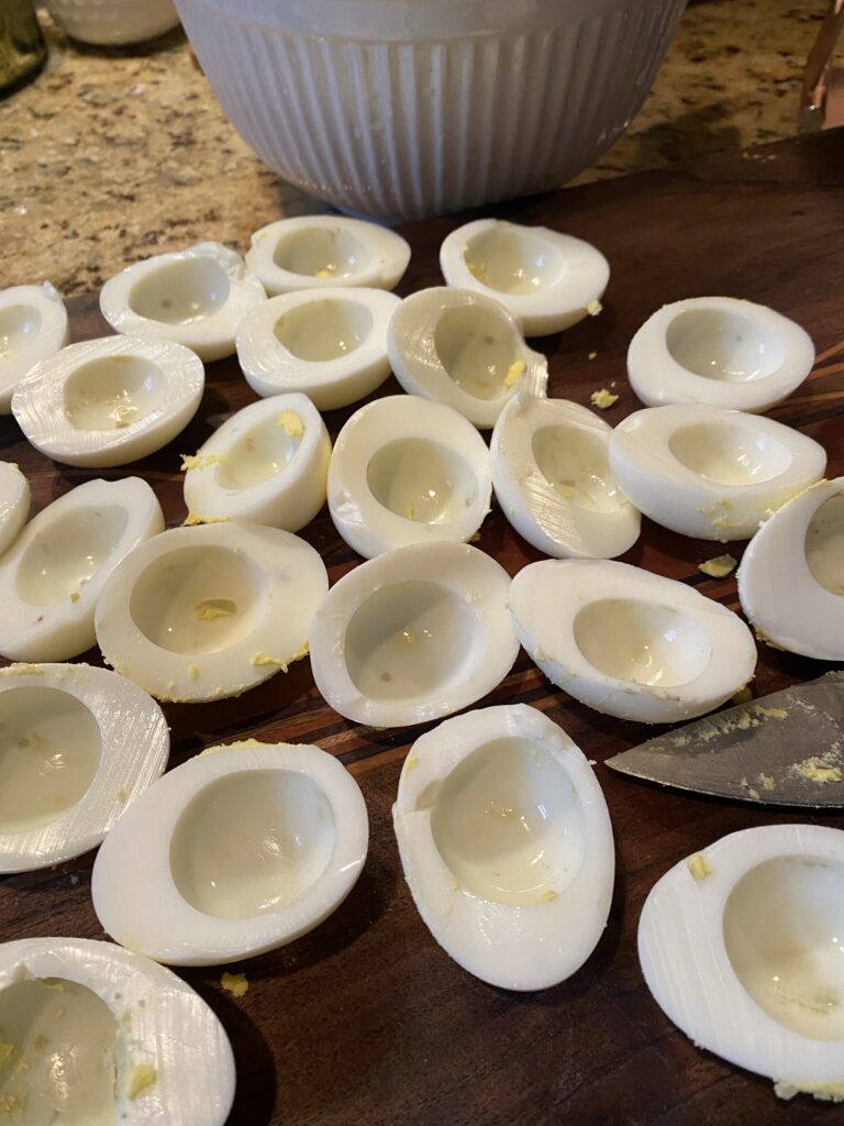 Hard boiled egg whites that have been split in half and hollowed out