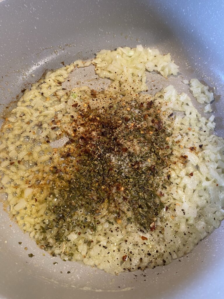 Diced onions and seasonings in a pan