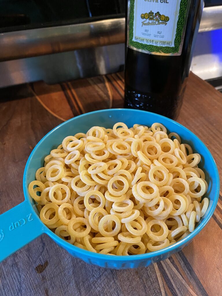 Ring shaped pasta in a 2 cup measuring cup
