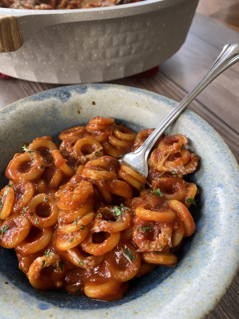 A bowl of homemade spaghetti os with a fork in it