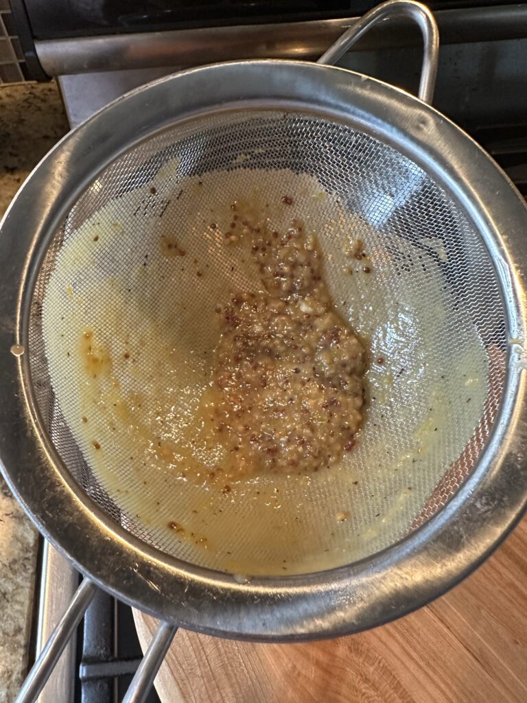 Mustard seed being strained