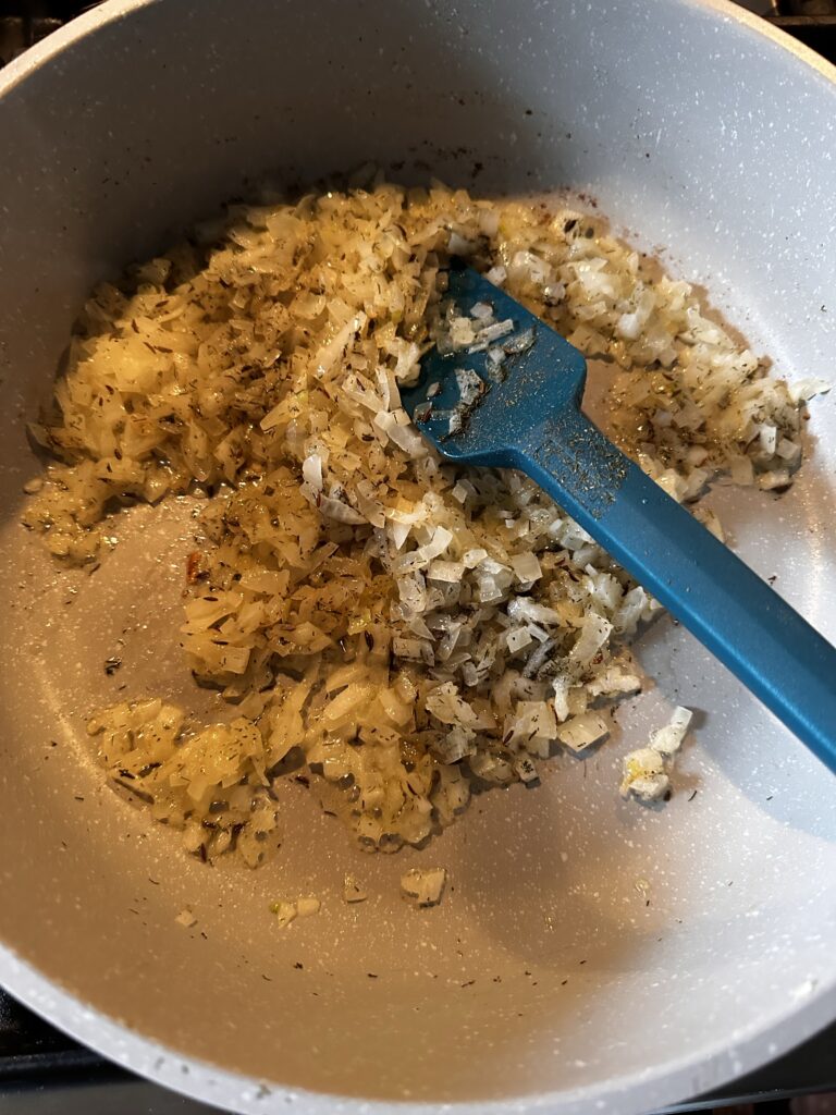 Onions and garlic cooking in a pan