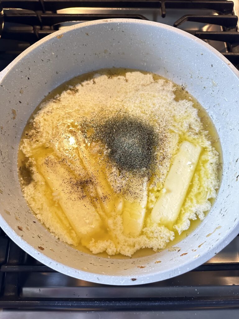 Seasoning and sticks of butter melting in a pot