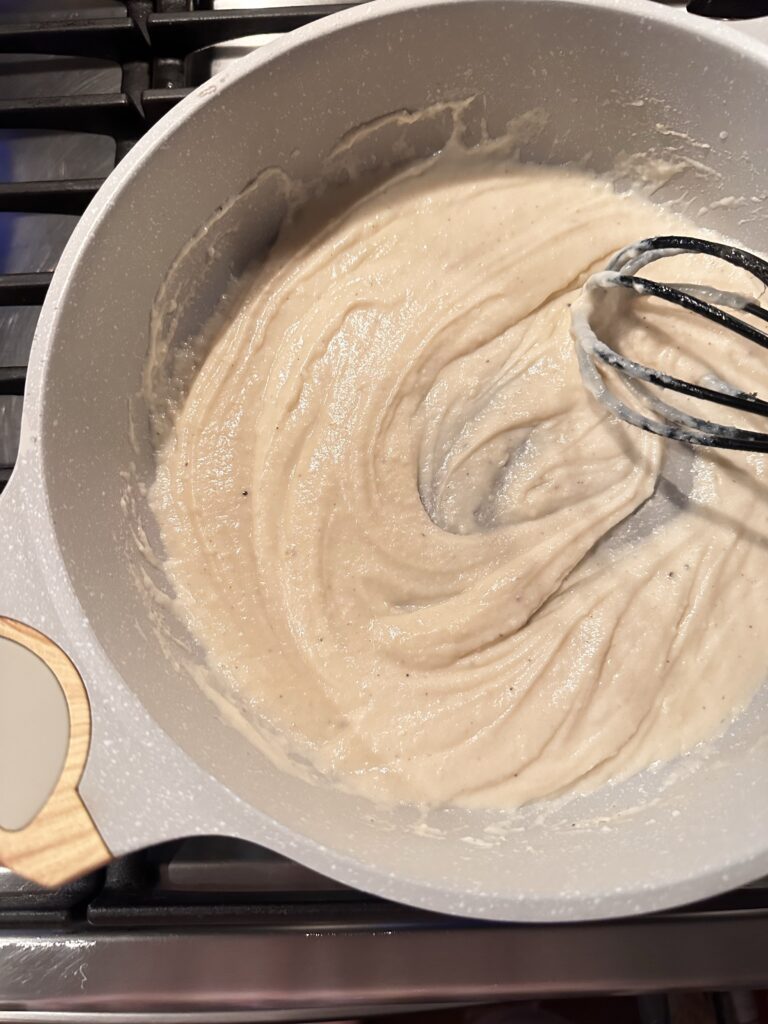 A roux being whisked in a pot