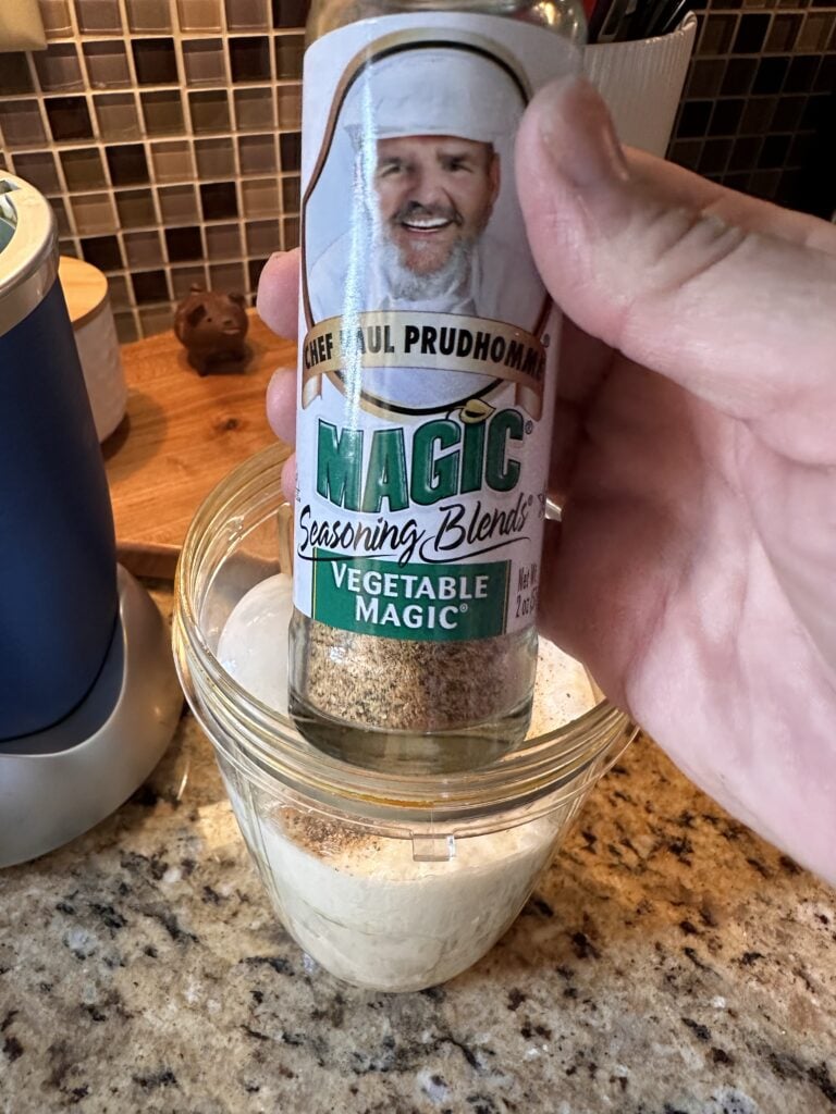 A shaker of Paul Prudhomme "Vegetable Magic" seasoning blend