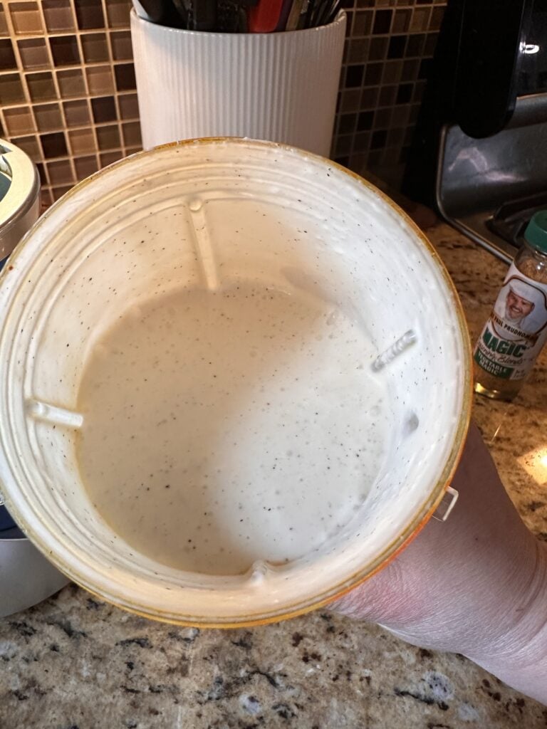 A blender with the copycat French Quarter dressing seen from above