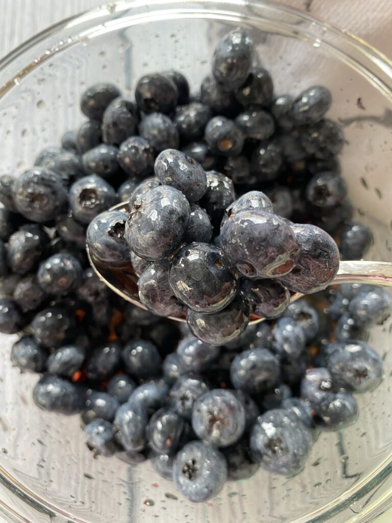 A spoon of macerated blueberries