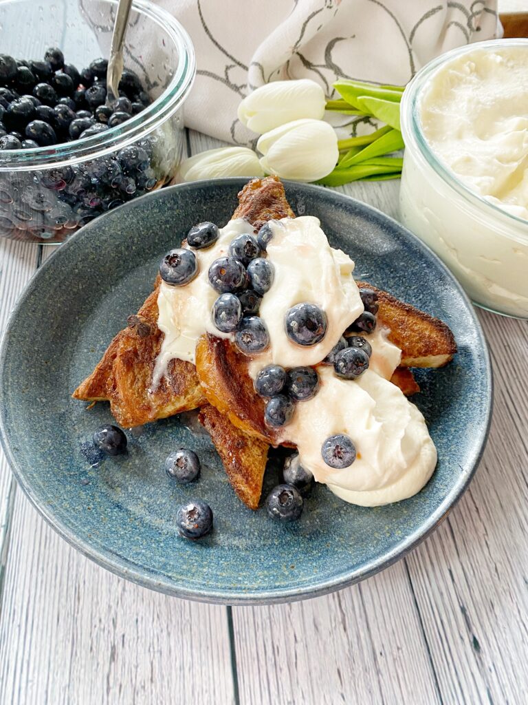 Blueberries and whipped cream over French toast