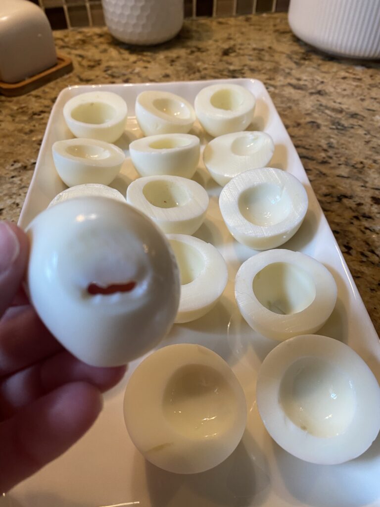 An egg white with a small hole in the bottom