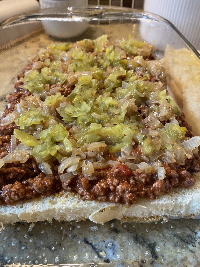 Sloppy joe meat with pickles and onions