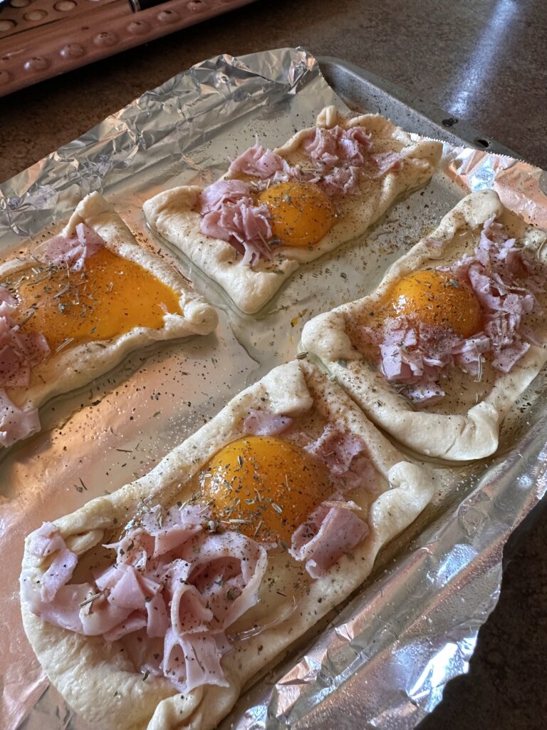Pastry dough topped with egg and ham