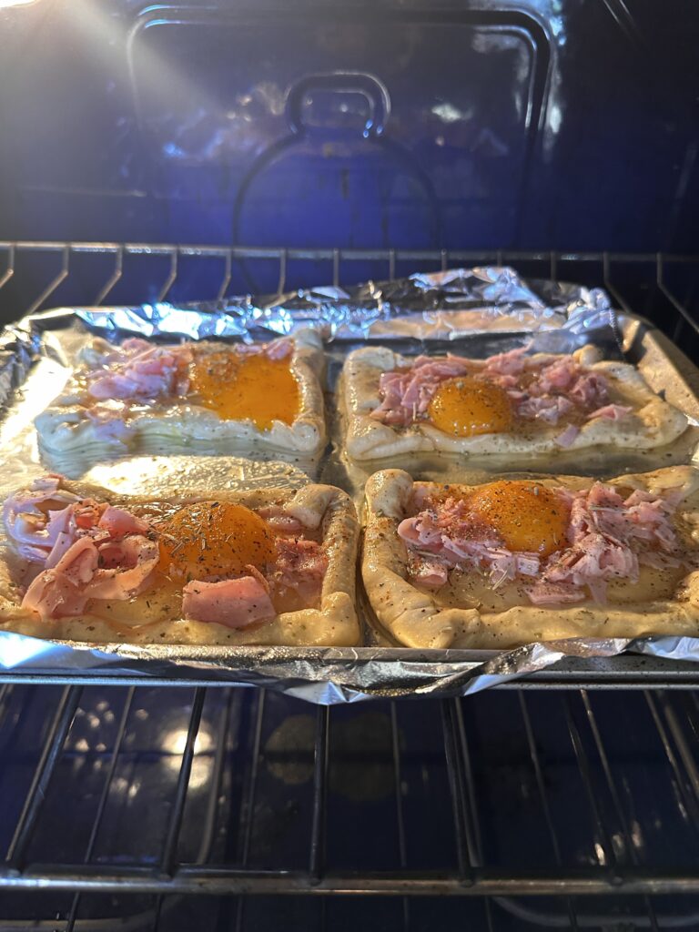 The eggs benedict pastries baking in the oven