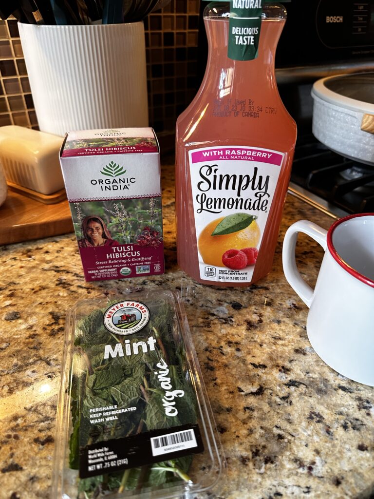 The ingredients for Derby Day Tea, including raspberry lemonade, hibiscus tea, and mint