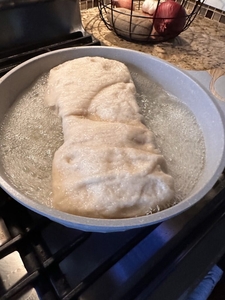 A loaf of bread steaming in a pan