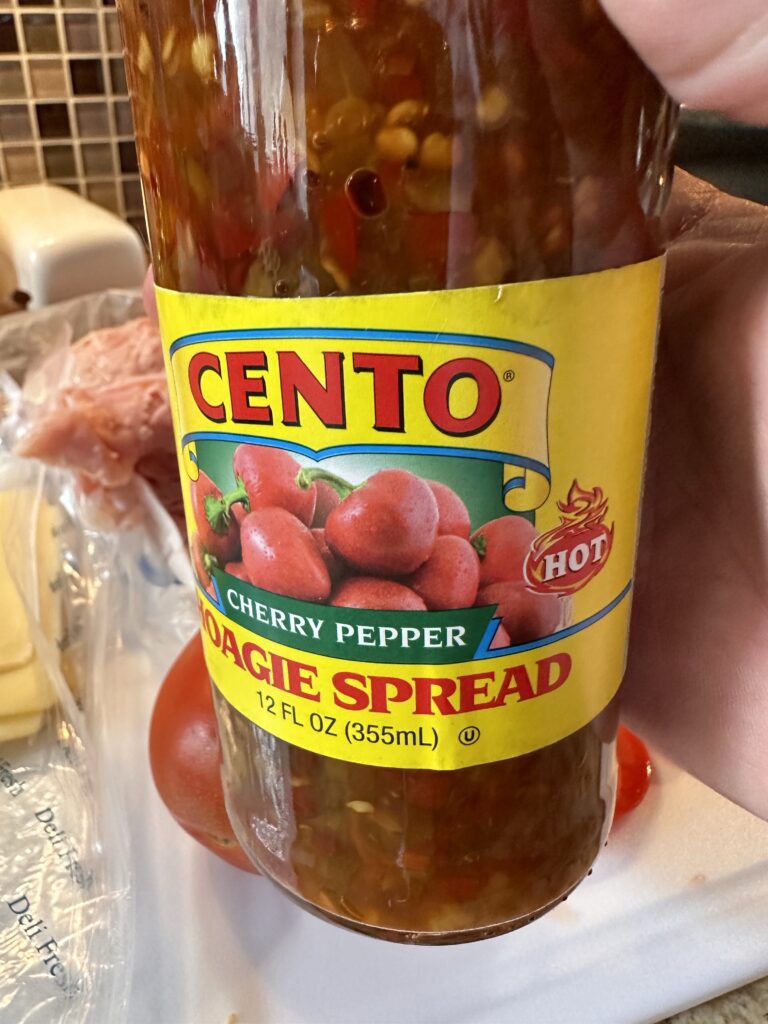 A close up of a jar of cherry pepper hoagie spread