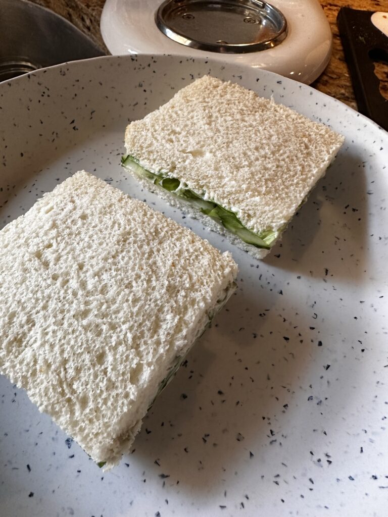 Two cucumber cream cheese sandwiches cut into squares