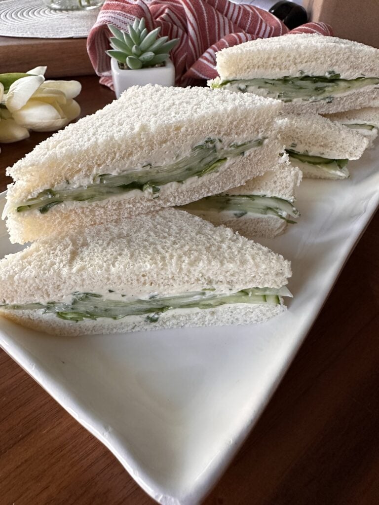 Cucumber cream cheese sandwiches on a white plate