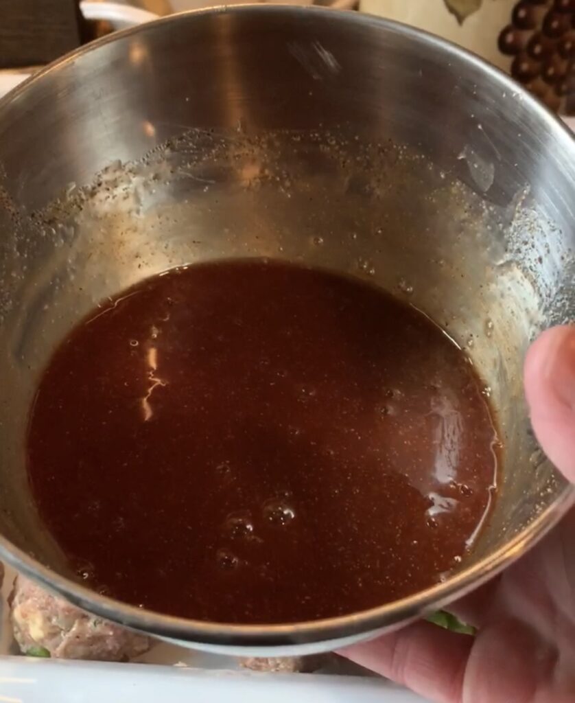 A metal bowl of sauce