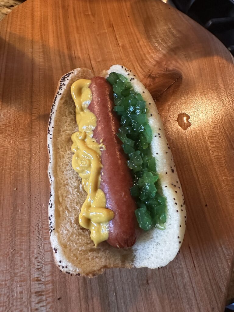 A hot dog with mustard and relish