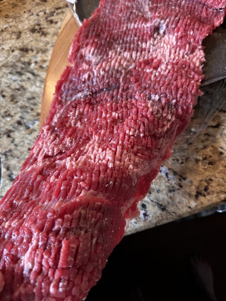 A close up of tenderized steak