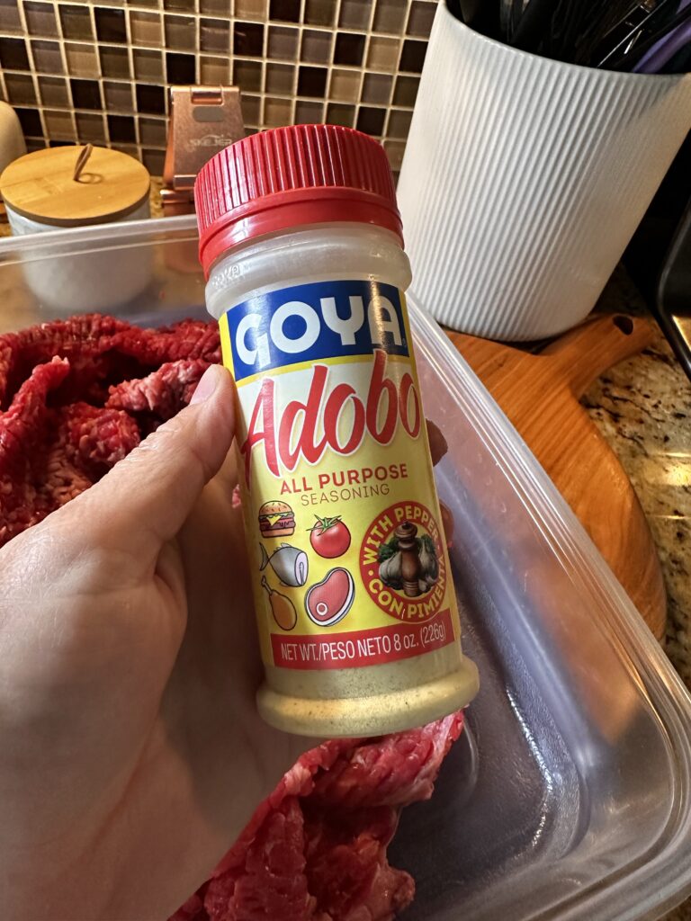 A bottle of Goya Adobo seasoning with pimento