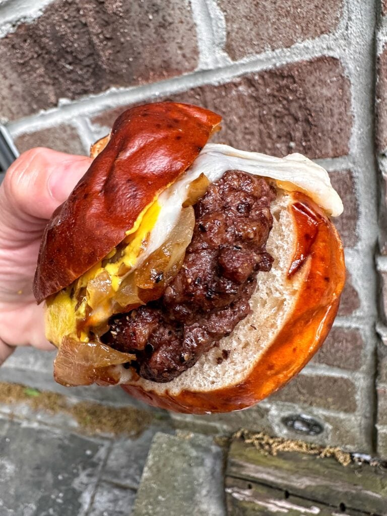 A close up of a cheesy beef slider