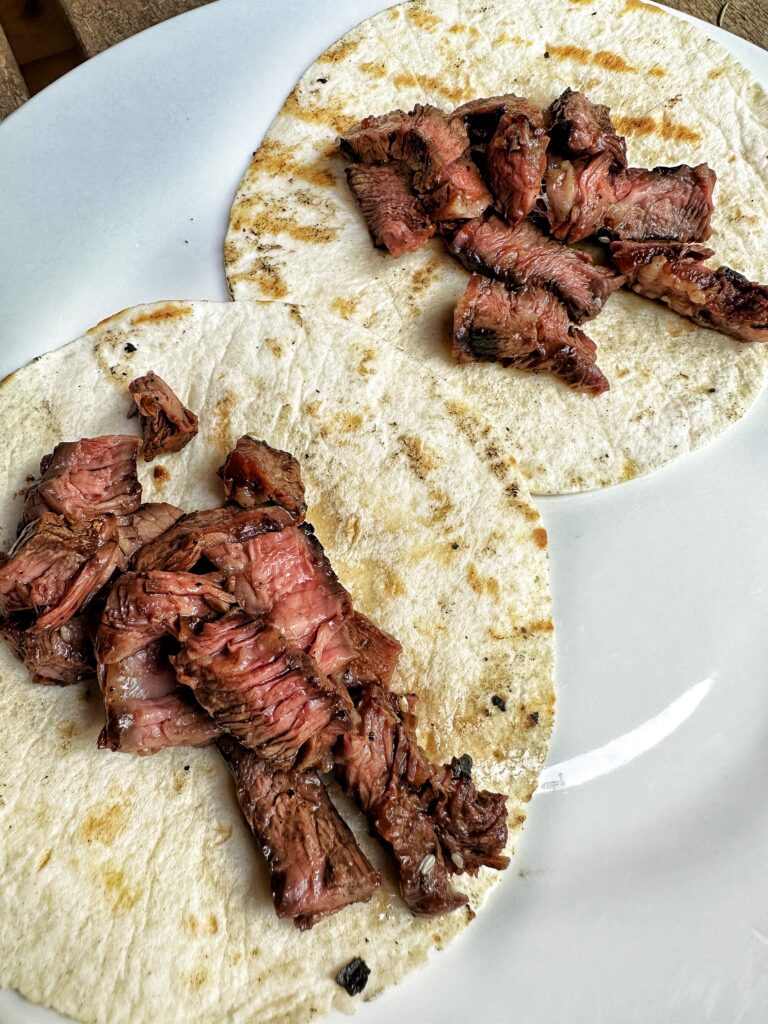 Pieces of steak on tortillas