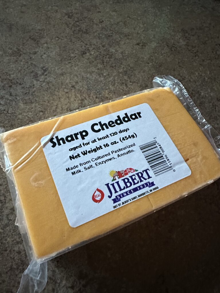 A block of sharp cheddar cheese