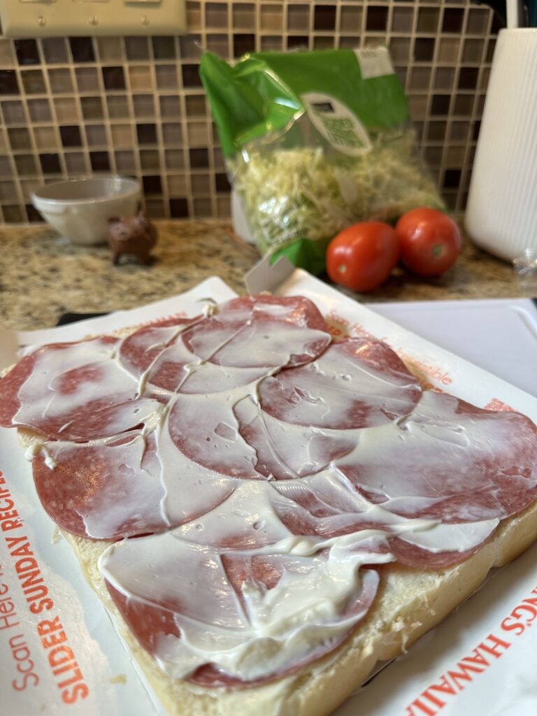 Mayo spread on the salami on the half roll slab