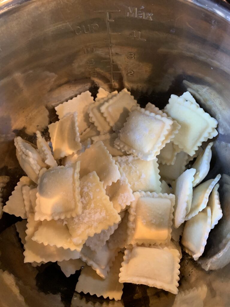 Frozen ravioli in a metal bowl