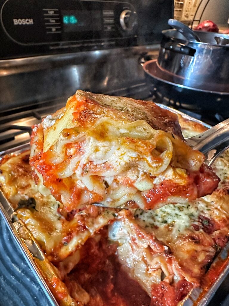 A slice of Classic Lasagna being lifted out of the dish