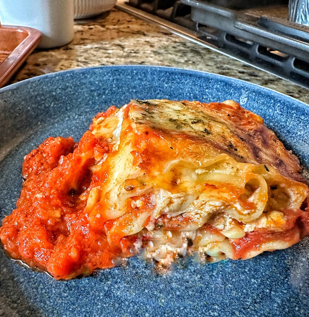 A piece of lasagna on a blue plate