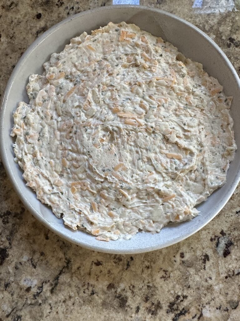 The dip seen from above before the pepper jelly is added