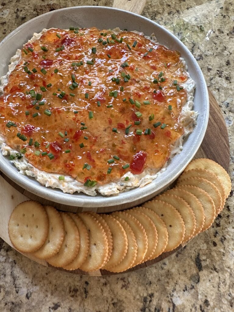 Pepper Jelly Cheese Dip with crackers laid out along the side