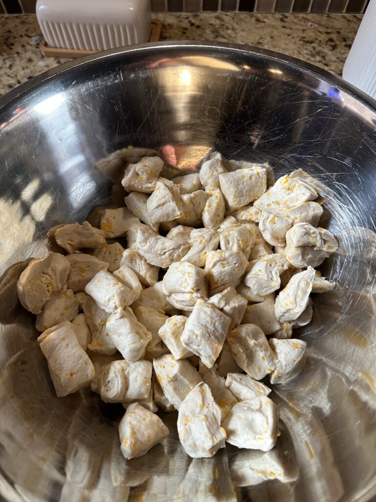 Cubes of biscuit dough in a metal bowl