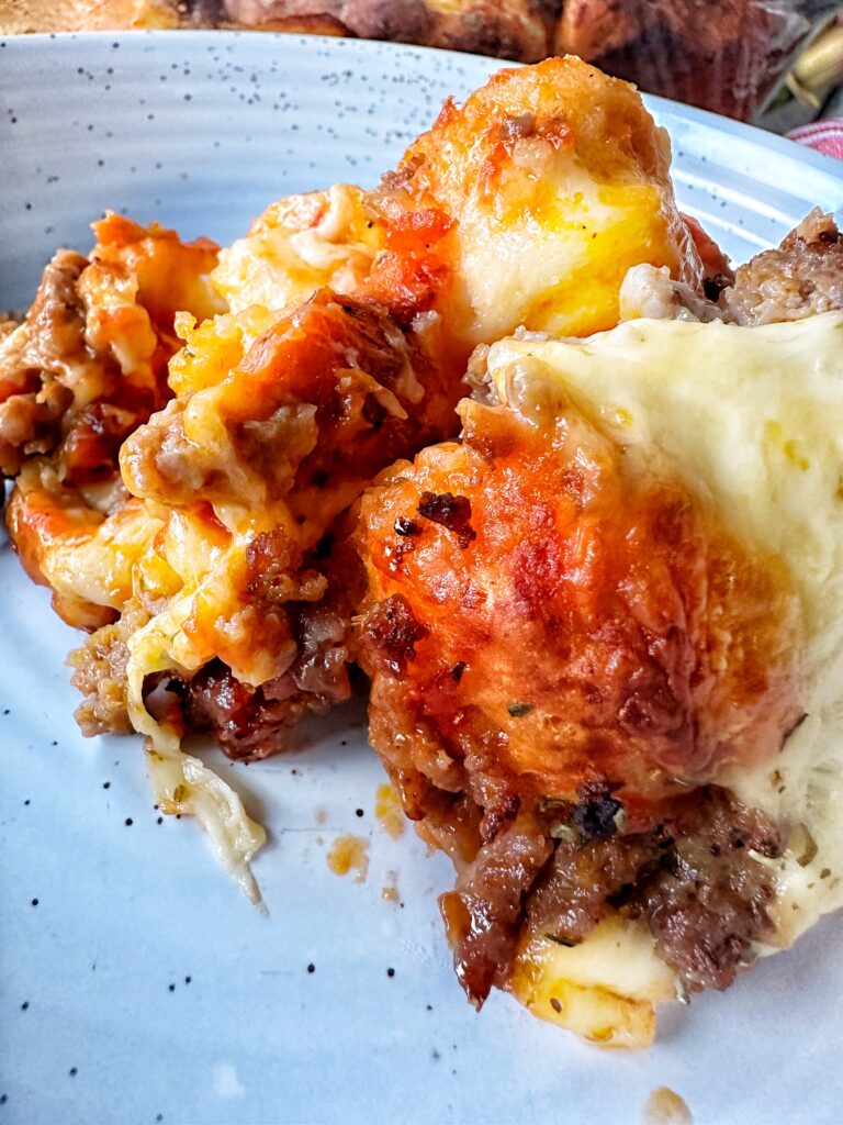 A piece of puffy pizza bake on a plate