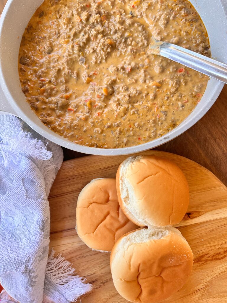 The cheesy ground beef mix next to three buns