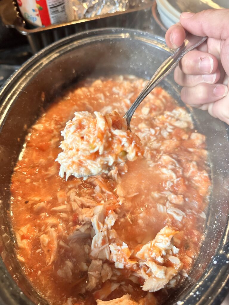 Cooked shredded chicken in red sauce