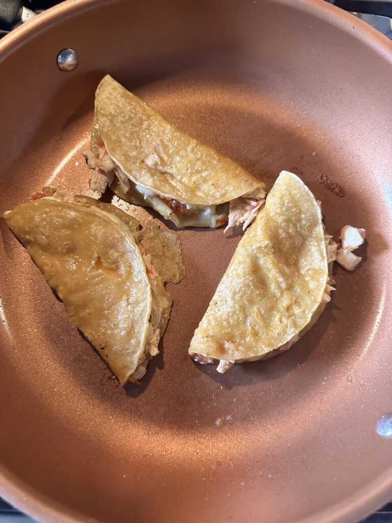 The chicken and cheese tacos folded over to crisp in the pan