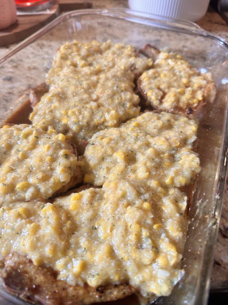 The pork chops covered with the corn mixture