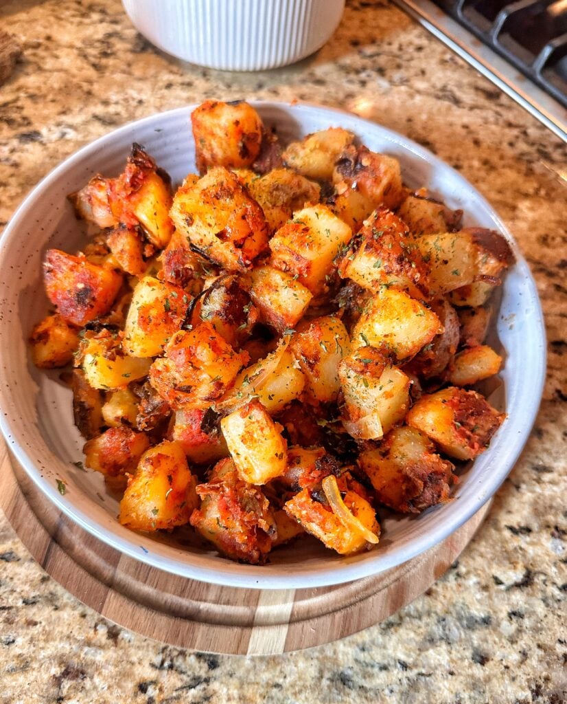 Tangy Tomato Fried Potatoes in a white bowl.
