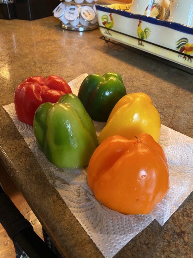 Bell peppers of various colors on a paper towel